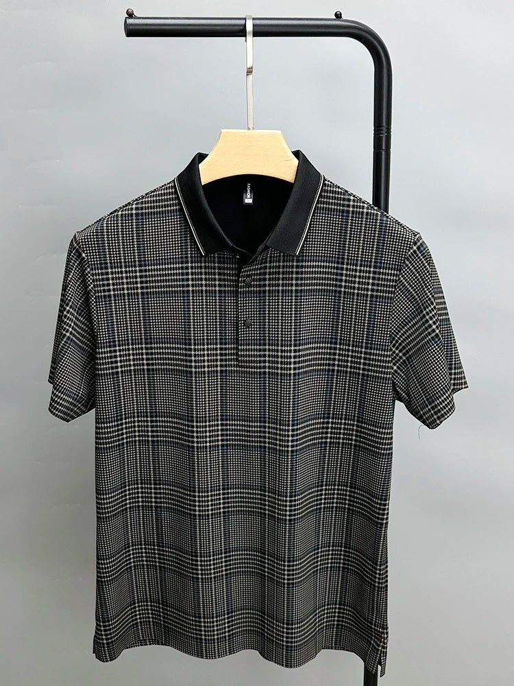 A short-sleeved, black and white plaid polo shirt with a breathable black collar, displayed on a wooden hanger against a plain light gray background.