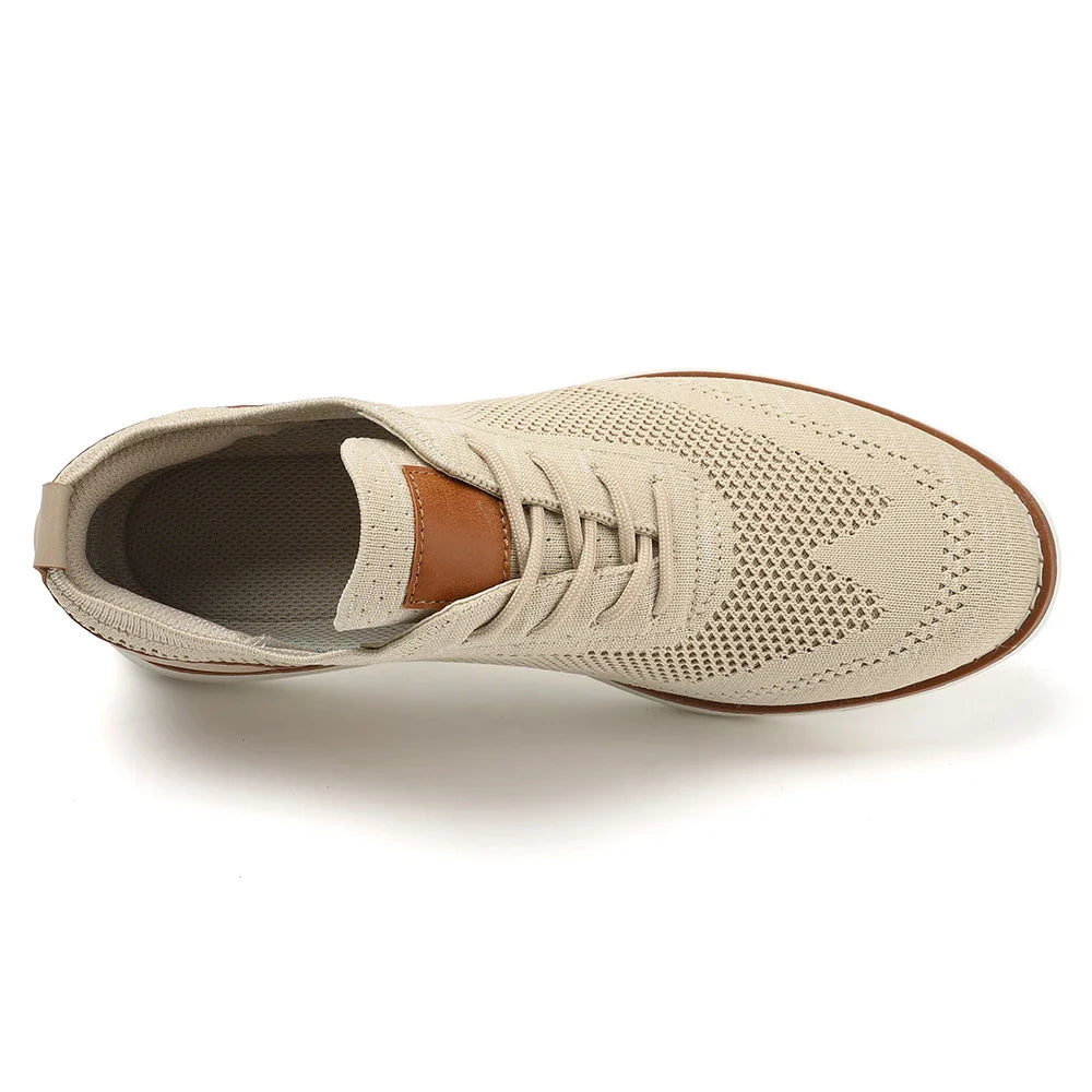 Top view of a beige breathable knit sneaker with a brown accent on the tongue, beige laces, and a textured rubber sole. The lightweight sneaker features a perforated upper, perfect for business casual shoes.