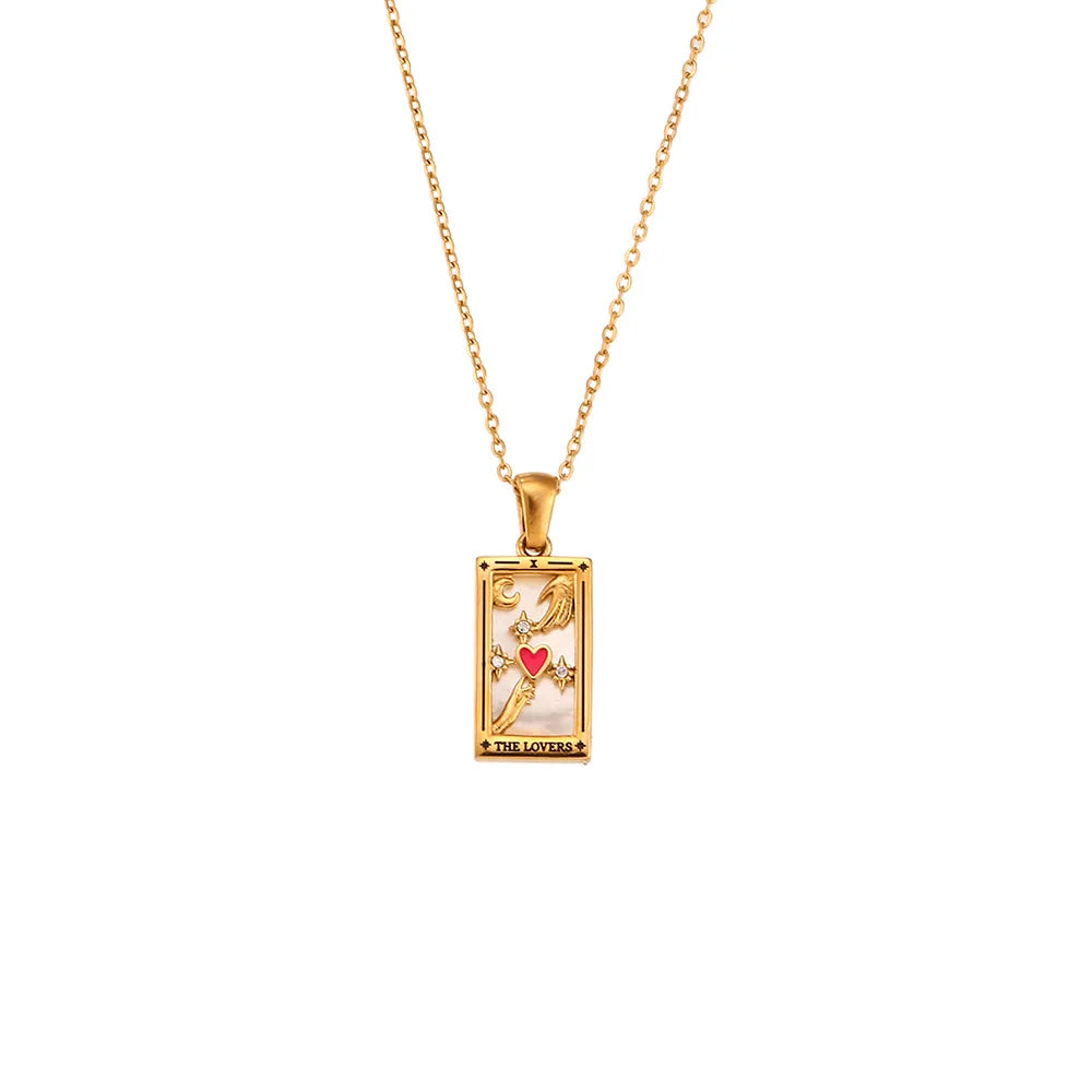 A gold chain Solaris Pendant Necklace with a rectangular, 18K gold-plated pendant featuring colorful symbols—including a red heart, stars, and the words THE LOVERS—on a tarot card-inspired design accented with blue enamel.