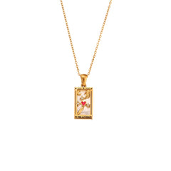 A gold chain Solaris Pendant Necklace with a rectangular, 18K gold-plated pendant featuring colorful symbols—including a red heart, stars, and the words THE LOVERS—on a tarot card-inspired design accented with blue enamel.