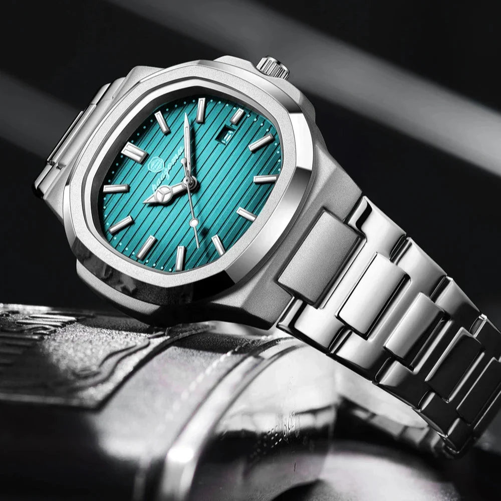 A luxury silver wristwatch with a teal, textured dial and silver hour markers rests on a dark, reflective surface, its stainless steel design showcased at an angle with dramatic lighting and a blurred background.