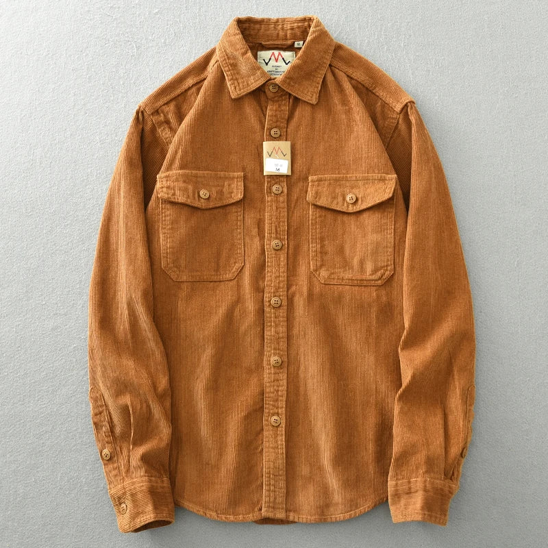 A brown heavyweight cotton button-up shirt featuring corduroy detailing, long sleeves, and two chest pockets, displayed on a flat light gray surface.