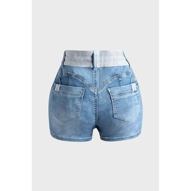 Back view of light blue high-waisted denim shorts crafted from premium cotton, featuring two large back pockets, white belt loops, and visible stitching detail on a plain background.