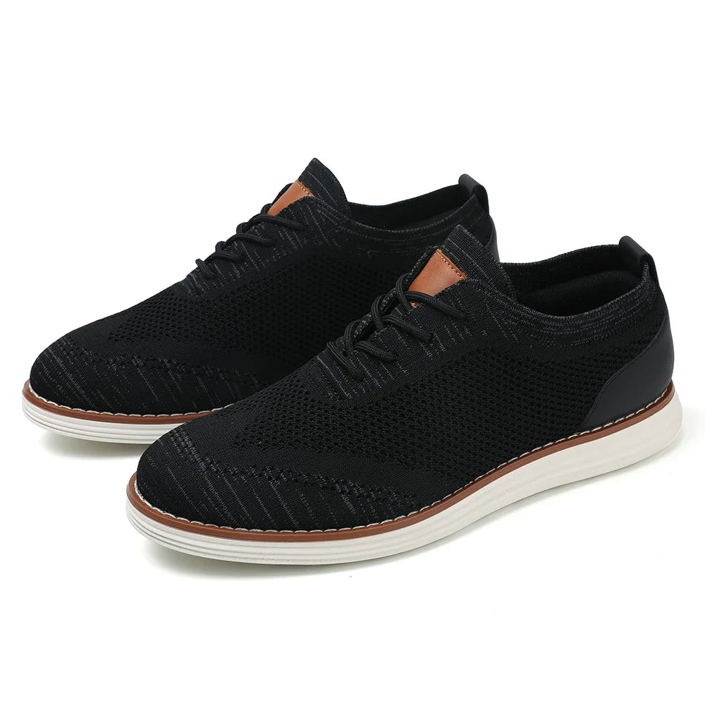 A pair of black breathable knit sneakers with white soles, light brown detailing near the laces, and a sleek, casual style perfect for everyday wear.