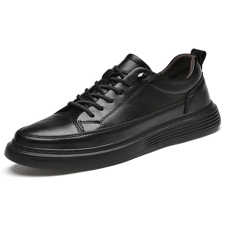 A black genuine leather sneaker with black laces, a textured sole, and a low-top Italian court shoe design, displayed on a white background.