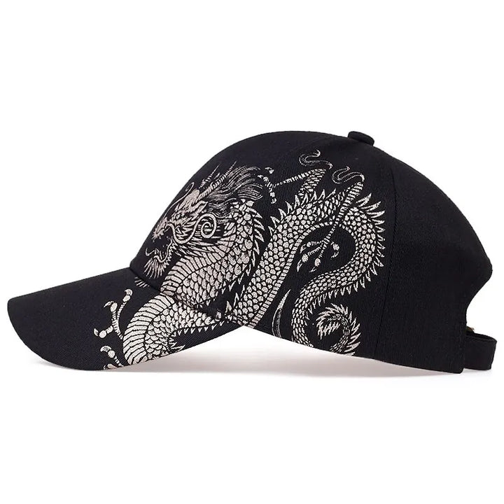 A black dragon cap featuring an intricate white dragon design embroidered along the side and brim, perfect for showcasing cultural pride.