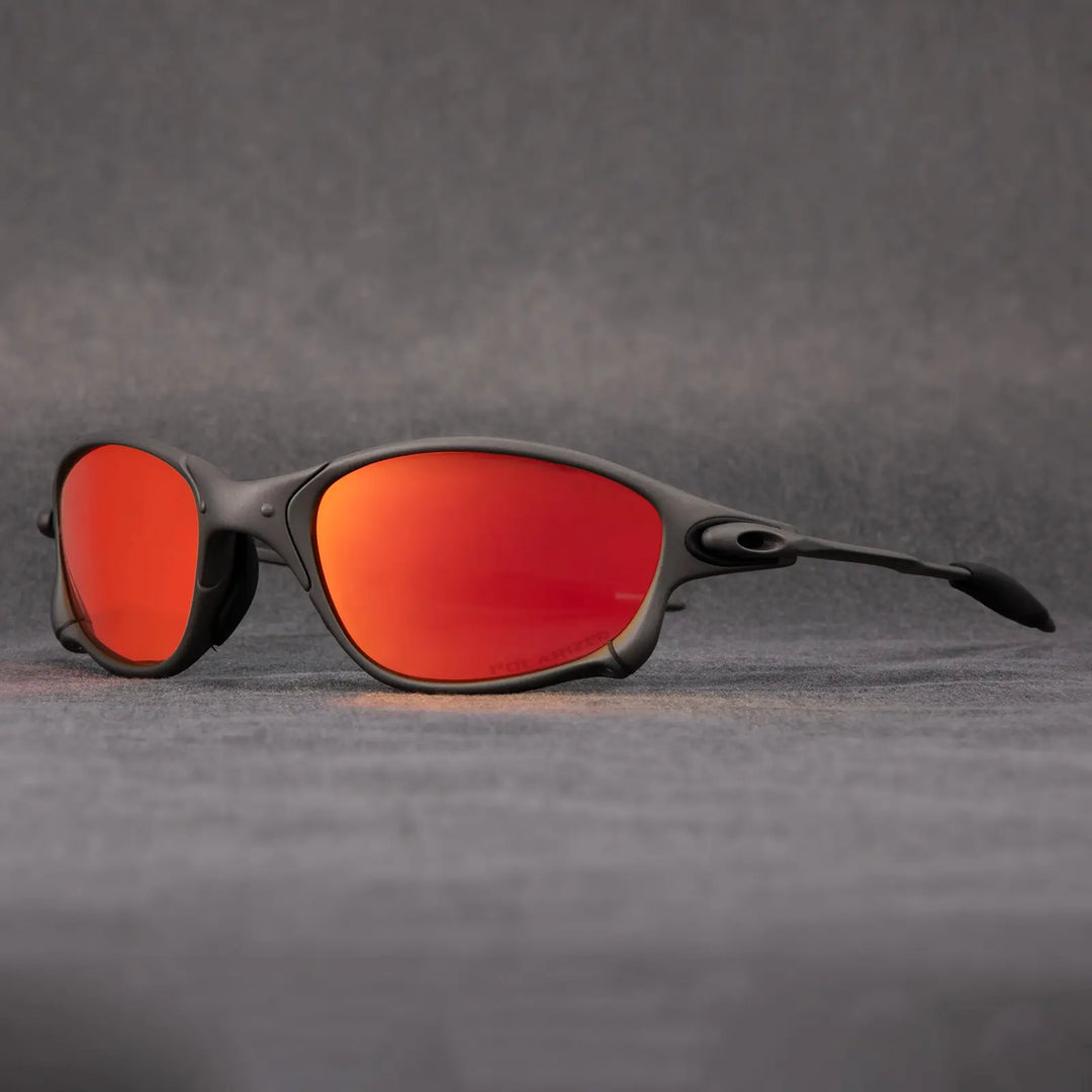 Matte black outdoor eyewear with curved frames and bright orange mirrored lenses, offering UV protection, displayed against a plain gray background.
