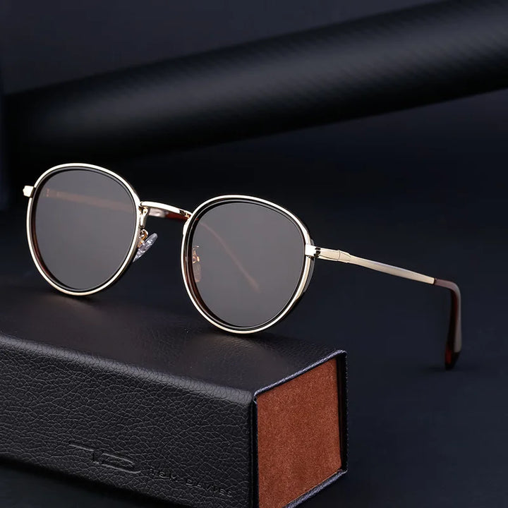 A pair of rounded sunglasses with gold frames and scratch resistant, UV400 protection lenses rests on a black leather case with brown interior, set against a dark background.