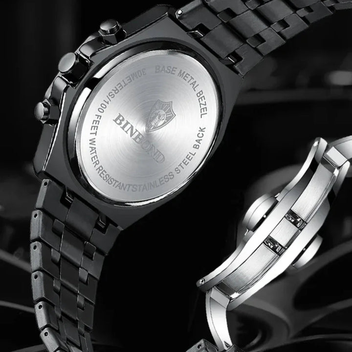 Close-up of the back of a stainless steel watch by BINBOND, featuring engraved water resistance details and a metal link bracelet. The clasp is also visible beside the watch, showcasing its precision quartz movement.