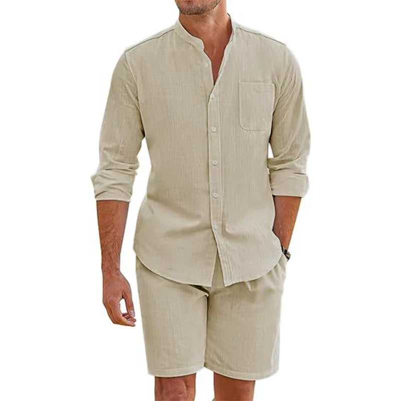 A man wearing a vintage stand collar shirt with a chest pocket and matching baggy shorts. The cotton linen outfit is casual and made of lightweight fabric, perfect for relaxed days.