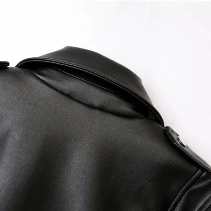 Close-up of the upper back and collar of a black leather jacket with an adjustable waist belt, set against a plain white background. The material appears smooth and slightly shiny.