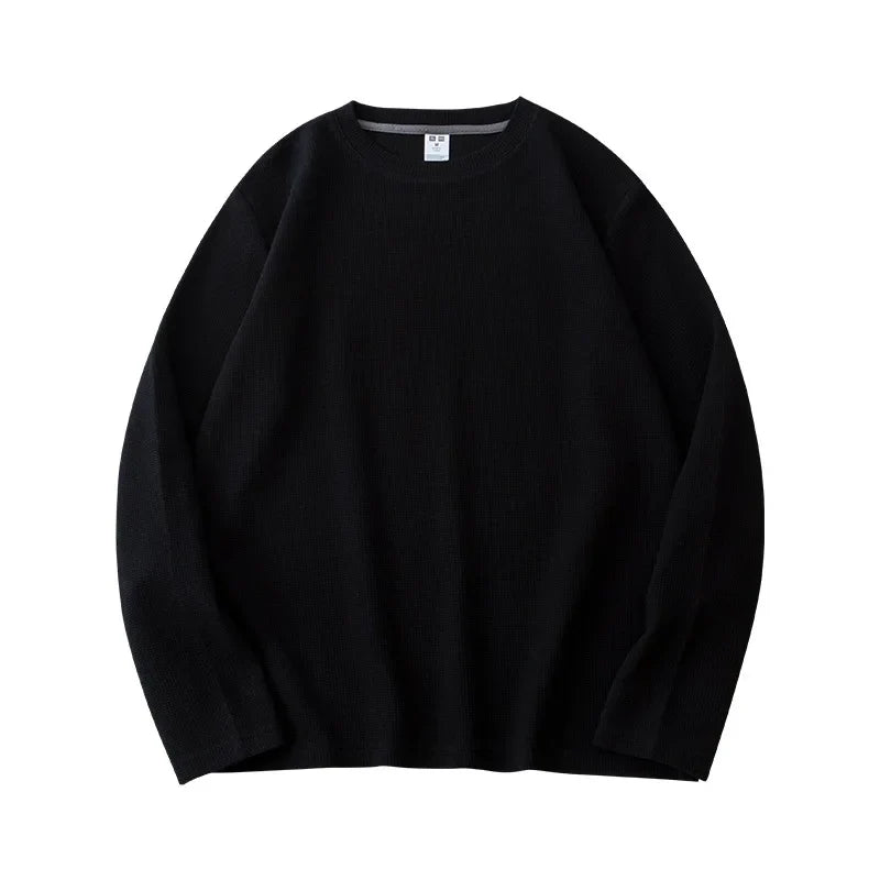 A plain black heavyweight long-sleeve shirt with a classic crew neck is laid flat on a white background.