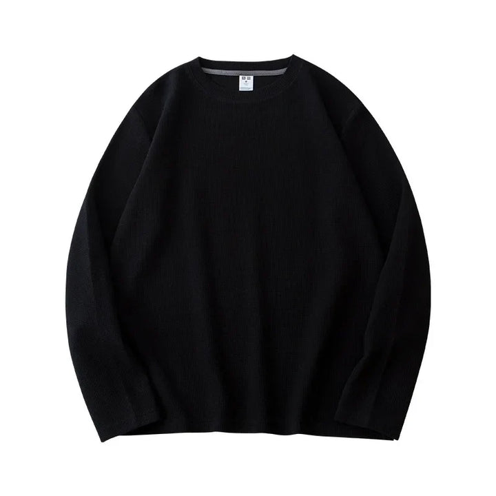 A plain black heavyweight long-sleeve shirt with a classic crew neck is laid flat on a white background.