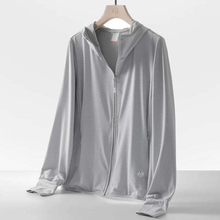 A light gray zip-up hooded jacket with long sleeves, crafted from quick-drying fabric, displayed on a wooden hanger against a plain white background. The jacket features a subtle smiley face logo near the hem.