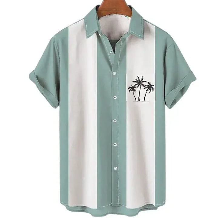 A short-sleeve Hawaiian shirt with wide vertical white and light green stripes, rolled sleeves, and a small palm tree graphic on the left chest pocket brings tropical vibes, displayed on a hanger.