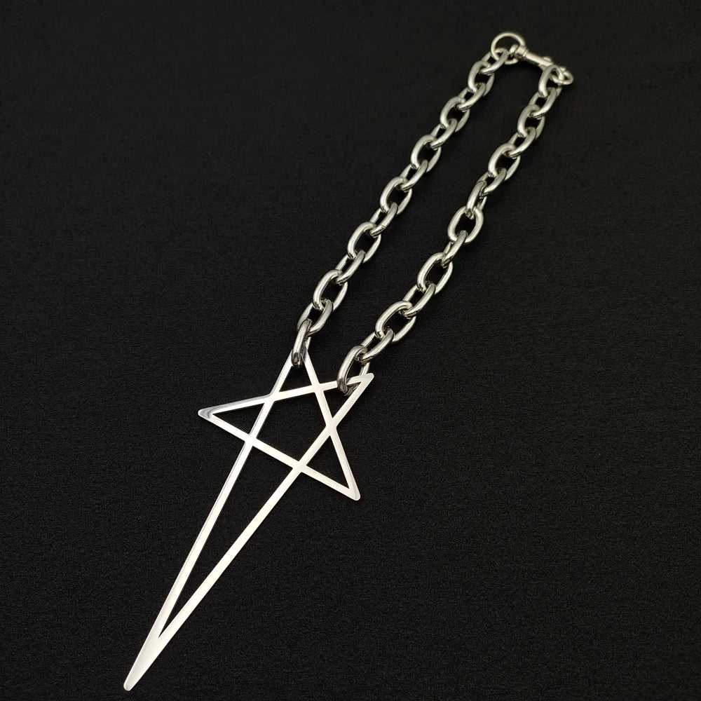 A silver stainless steel necklace with a large, geometric pendant featuring intersecting straight lines, displayed on a black background—a bold statement piece for streetwear jewelry lovers.