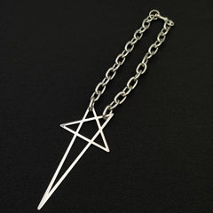 A silver stainless steel necklace with a large, geometric pendant featuring intersecting straight lines, displayed on a black background—a bold statement piece for streetwear jewelry lovers.