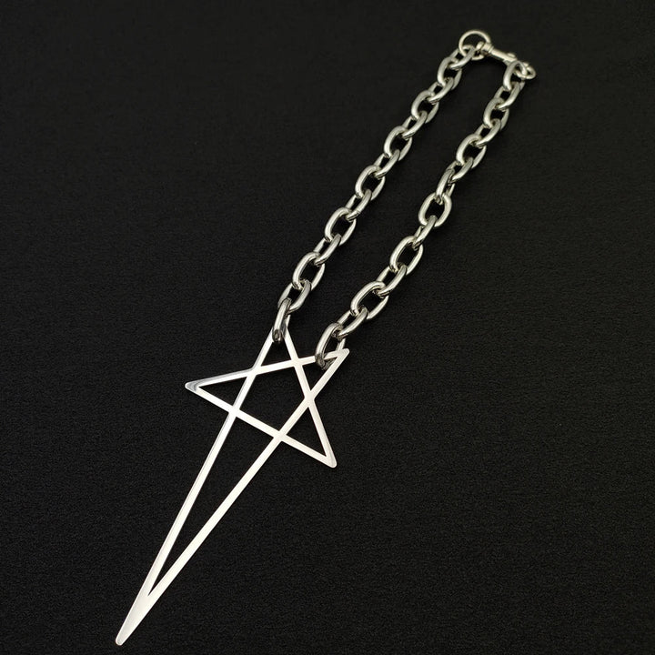 A silver stainless steel necklace with a large, geometric pendant featuring intersecting straight lines, displayed on a black background—a bold statement piece for streetwear jewelry lovers.