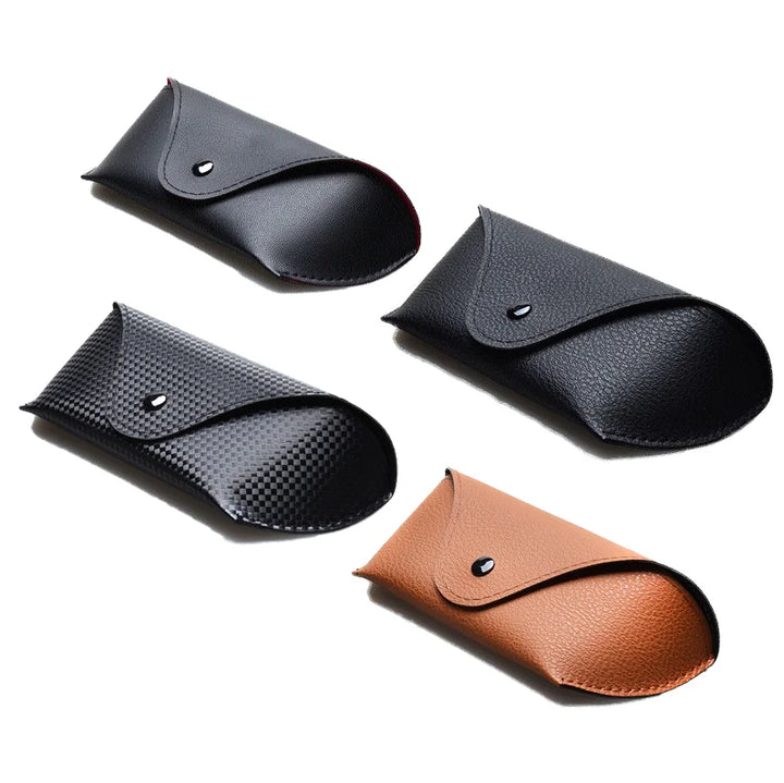 Four protective eyeglass cases in different textures and colors—smooth black, pebbled black, patterned black, and tan vegan leather—are arranged on a white background. Each case is closed with a snap button and can also be used as a sunglasses case.