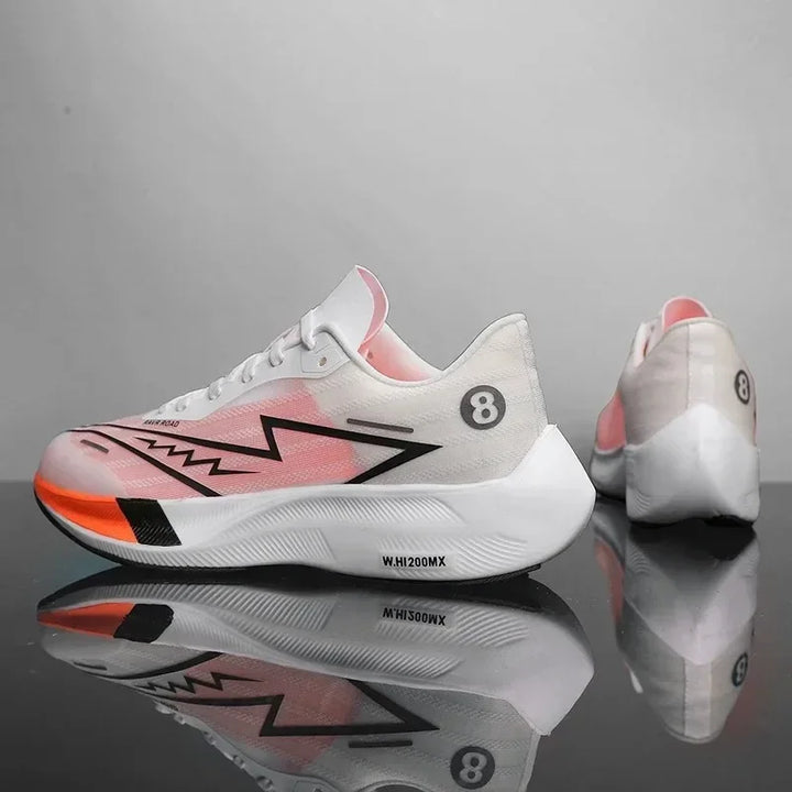 A pair of white running shoes with pink and black accents, zigzag design on the side, and number 8 on the heel. Featuring lightweight construction, one shoe faces forward while the other shows the back. Both sit on a reflective surface.