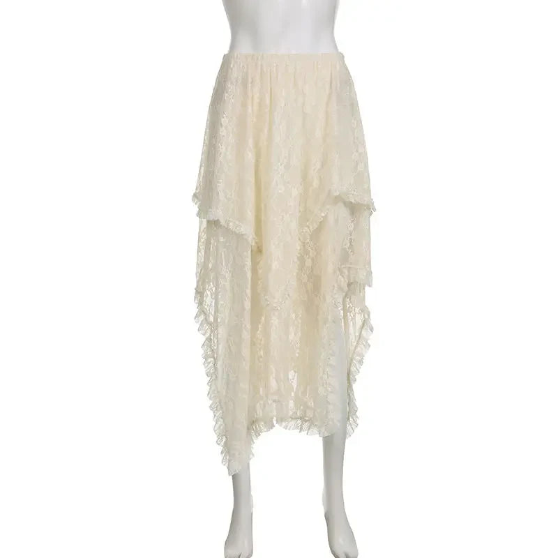 A cream-colored, silky lace asymmetrical skirt with a high waist, featuring a high-low hem, layered ruffles, and a sheer, flowy texture displayed on a white mannequin.