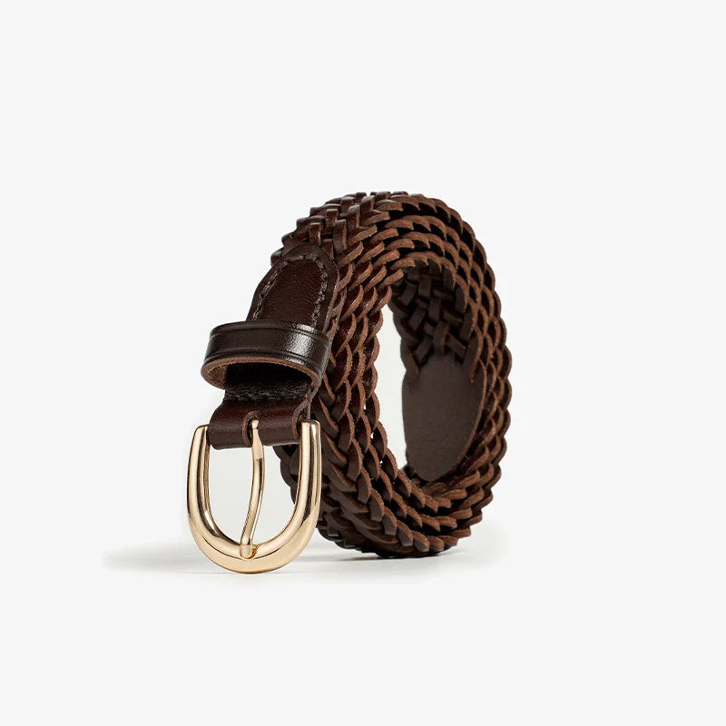 A coiled brown woven belt, crafted from Italian leather with artisanal craftsmanship, features a shiny gold buckle and is displayed on a plain white background.