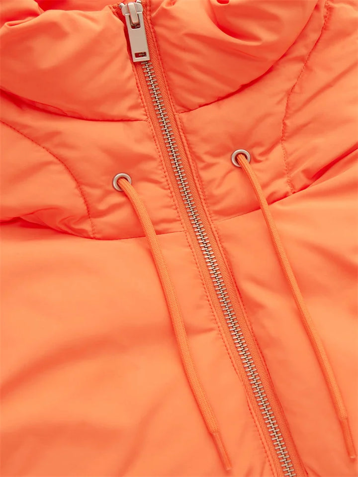Close-up of an orange puffer jacket featuring a silver zipper and two drawstrings on either side, crafted from durable material with visible stitching and a high, padded collar.