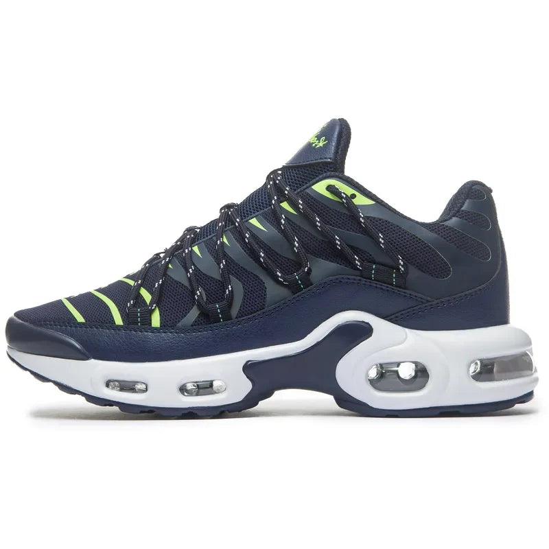 A navy blue and neon green athletic sneaker with a white sole, cushioned midsole, and visible air cushioning units, featuring wavy stripes and a breathable mesh upper for comfort.