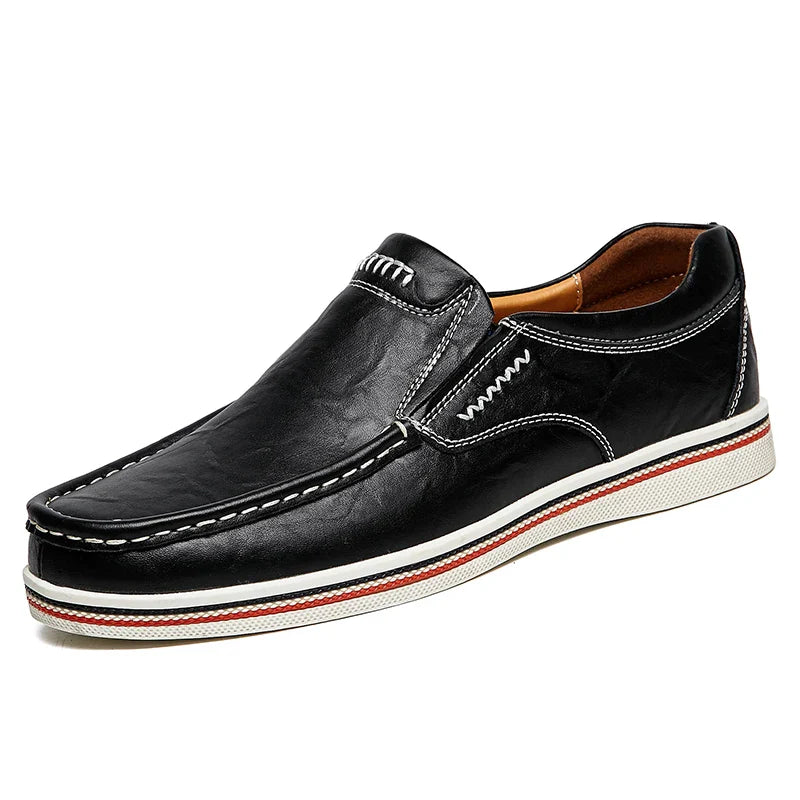 A black leather slip-on loafer with white stitching, a white sole, and a red stripe accent along the edge. These boat-style loafers feature a light brown interior for added comfort.
