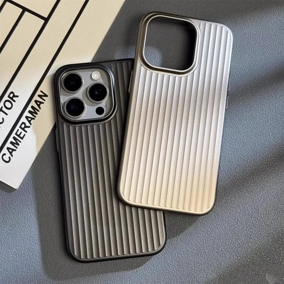 Two vertically ribbed phone cases, featuring a slim lightweight design, sit on a textured gray surface. The silver case is empty, while the dark gray titanium phone case securely holds a smartphone with three camera lenses visible.