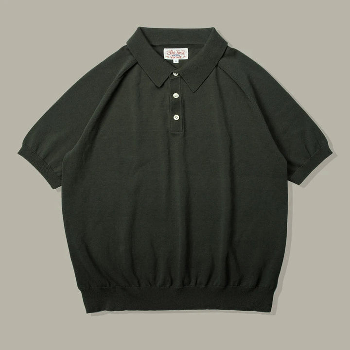A short-sleeved, dark green mens polo shirt in classic style, crafted from soft knit with a ribbed hem, three white buttons, and a pointed collar, displayed flat on a light gray background.
