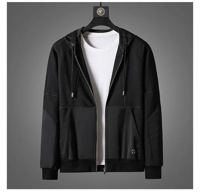 A black zipper hoodie with a hood and drawstrings, layered over a plain white t-shirt, is displayed on a hanger against a gray background—perfect as an activewear set for versatile comfort.