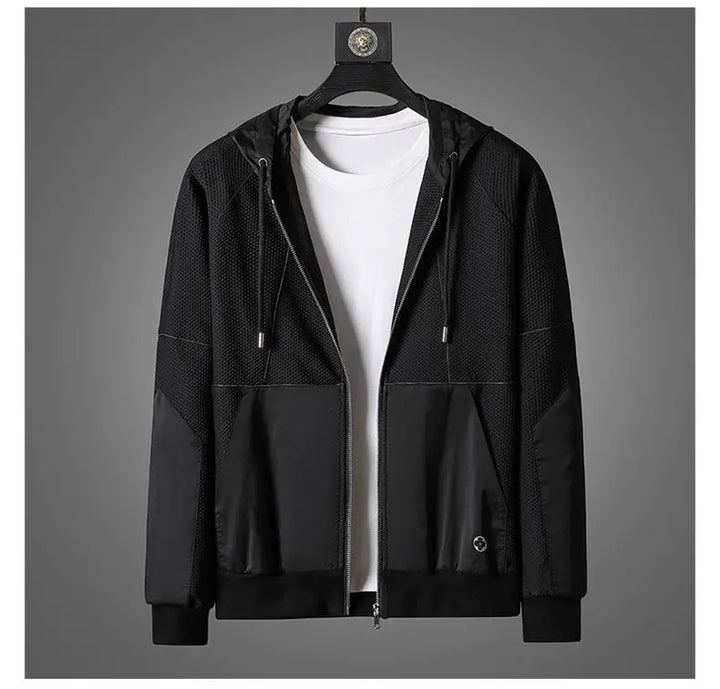 A black zipper hoodie with a hood and drawstrings, layered over a plain white t-shirt, is displayed on a hanger against a gray background—perfect as an activewear set for versatile comfort.