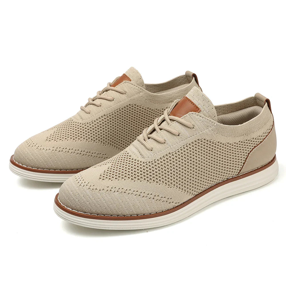 A pair of breathable knit oxford-style sneakers with white soles, tan accents on the tongue and heel, and decorative stitching, viewed at an angle on a white background for a casual style.