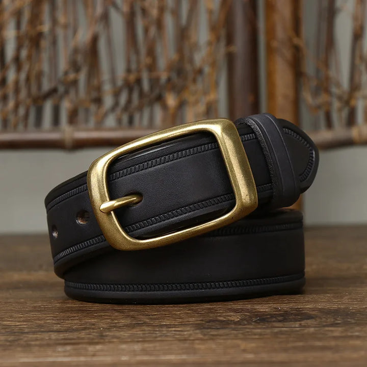 A black genuine leather belt with a brass rectangular buckle, coiled neatly on a wooden surface, stands out against a rustic background featuring woven wooden details.