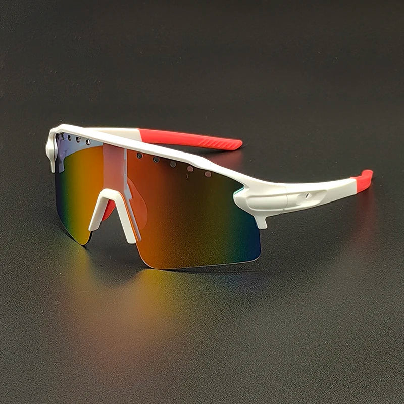 Sporty oversized sunglasses with a white frame, red temple tips, and large, reflective, rainbow-tinted polarized lenses are resting on a black surface.