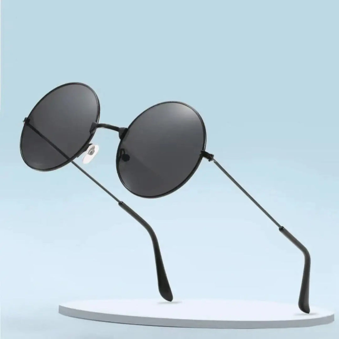 A pair of round sunglasses with thin frames and dark lenses, offering UV400 protection, is displayed on a minimalist, circular white platform against a light blue background.