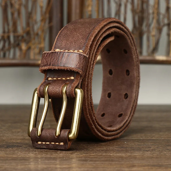 A brown genuine leather belt featuring a copper buckle, showcasing true heritage craftsmanship.