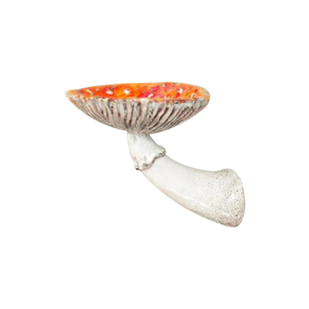 A ceramic object shaped like a mushroom with a white, curved stem and a wide, orange-red cap with textured details, this unique home decor piece features a naturalistic design and is displayed on a plain white background.