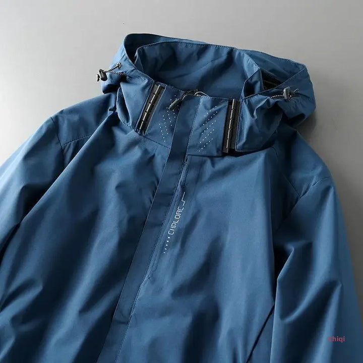 A blue hooded waterproof jacket with adjustable drawstrings and a front zipper, displayed on a flat gray surface. This breathable outdoor jacket features the brand name CEROCE printed vertically on the chest.