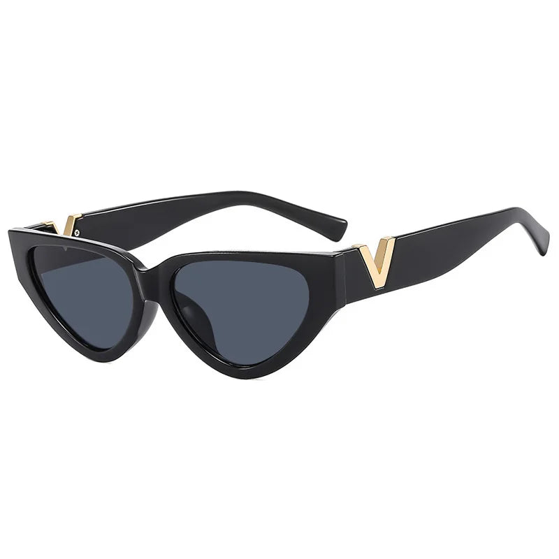 Black cat-eye sunglasses with a bold frame, dark lenses, and gold V accents on the upper corners offer stylish UV400 protection.