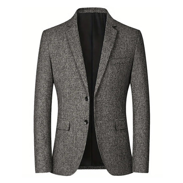 A grey textured men’s blazer with a notch lapel, front buttons, two lower flap pockets, and a chest pocket in a tapered fit for timeless style, displayed against a white background.