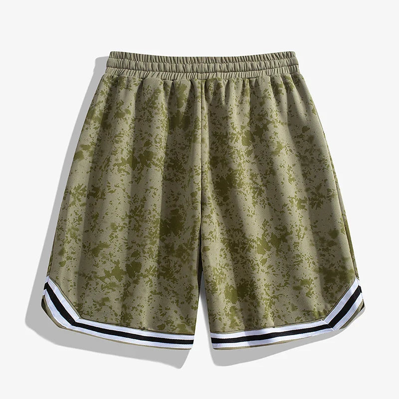 A pair of olive green Korean Edition Sports Shorts with a subtle splatter pattern, featuring a black and white striped trim at the hem and an elastic waistband, displayed on a plain white background.