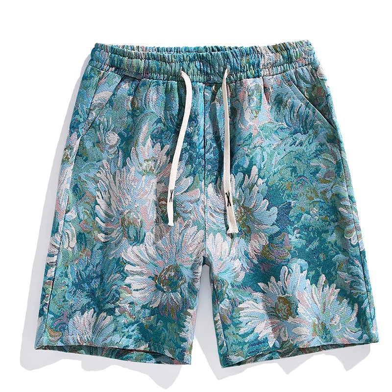Colorful designer shorts with an elastic waistband and white drawstrings, featuring a vibrant floral pattern in teal, blue, green, and white with large daisy-like flowers. Elevate your style with these premium quality shorts.