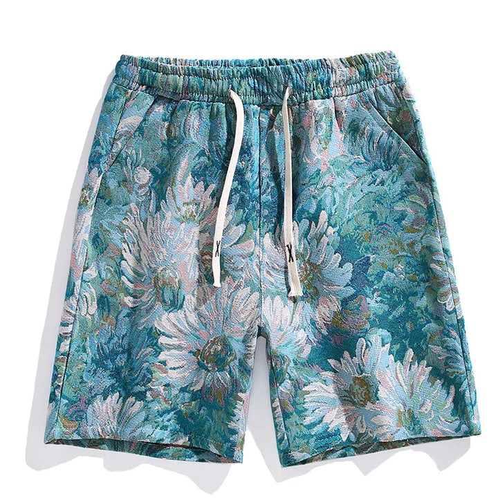 Colorful designer shorts with an elastic waistband and white drawstrings, featuring a vibrant floral pattern in teal, blue, green, and white with large daisy-like flowers. Elevate your style with these premium quality shorts.