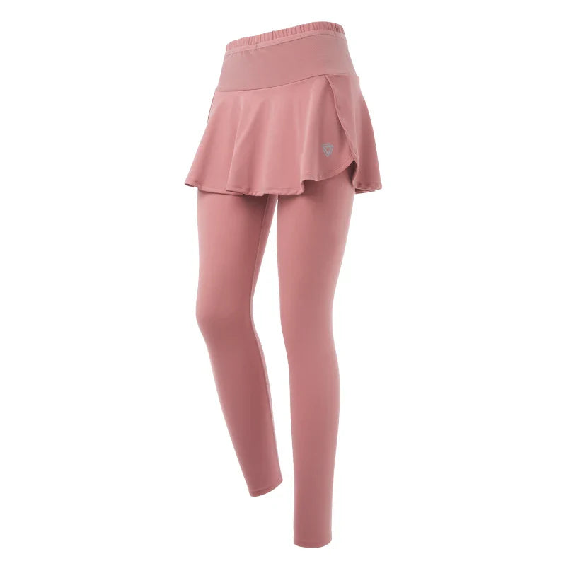 Pink skirted leggings with high-waisted support, featuring an attached flared skirt that covers the upper leggings for a layered, stylish look. Displayed on a white background.