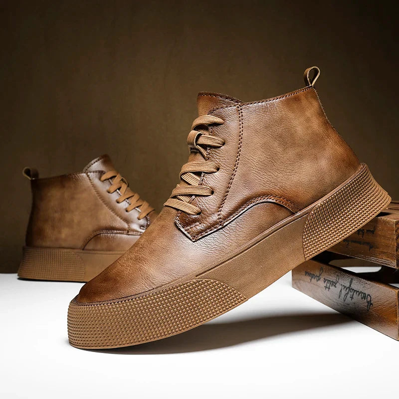 A pair of stylish brown leather vintage-inspired high-tops with textured rubber soles, displayed against a brown background with one shoe propped up on books and the other standing upright.