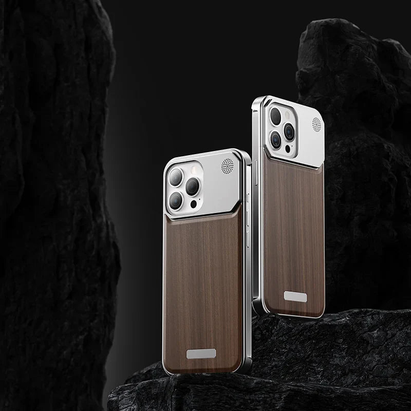 Two smartphones with a sleek design and luxury phone case, featuring wood-patterned backs and metallic edges, stand upright against a dark, rocky background. The phones have prominent camera modules and minimalist, modern aesthetics.
