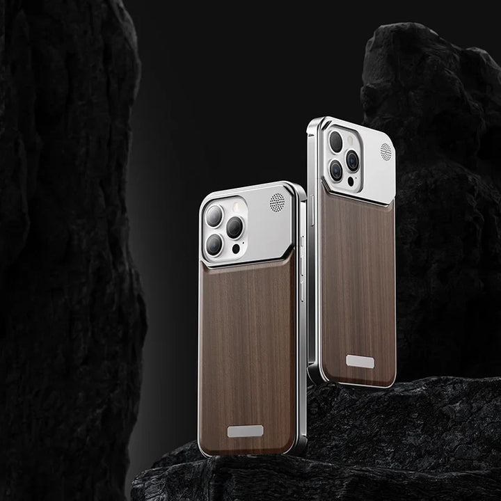 Two smartphones with a sleek design and luxury phone case, featuring wood-patterned backs and metallic edges, stand upright against a dark, rocky background. The phones have prominent camera modules and minimalist, modern aesthetics.