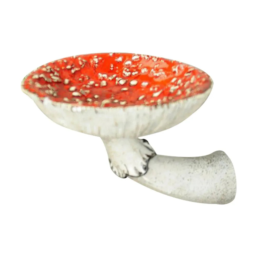 A ceramic sculpture featuring a naturalistic design, this red-and-white spotted mushroom cap with a white stem makes for unique home decor, set against a plain white background.